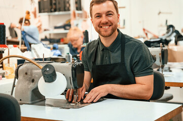 Working by sewing machine. Technician is indoors