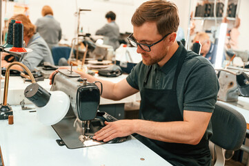 Working by sewing machine. Technician is indoors