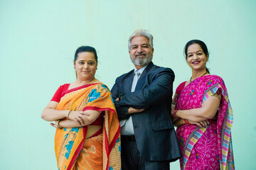 Senior businessman standing with women group.