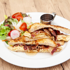 French toast with omelette and bacon for breakfast, brunch
