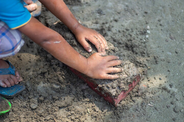 A boy marks the ground with his hands