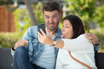 portrait of funny couple man and woman taking a selfie