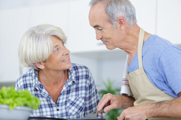 smiling mature loving couple family cooking at home