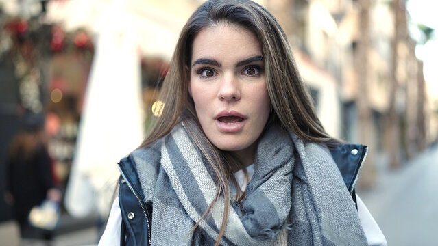 Young beautiful hispanic woman standing with surprise expression at street