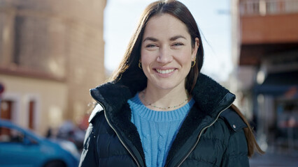 Young caucasian woman smiling confident standing at street