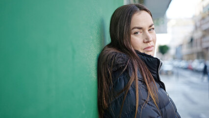 Fototapeta premium Young caucasian woman standing with serious expression at street