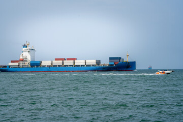 Side view of Cargo ship carrying container from custom container depot go to ocean concept freight shipping by ship service on blue sky .Freight Forwarding Service