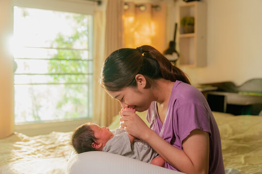 Asian mom with newborn at home
