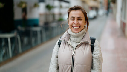 Fototapeta premium Middle age hispanic woman smiling confident standing at street