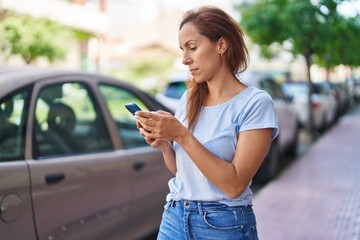 Young woman using smartphone at street