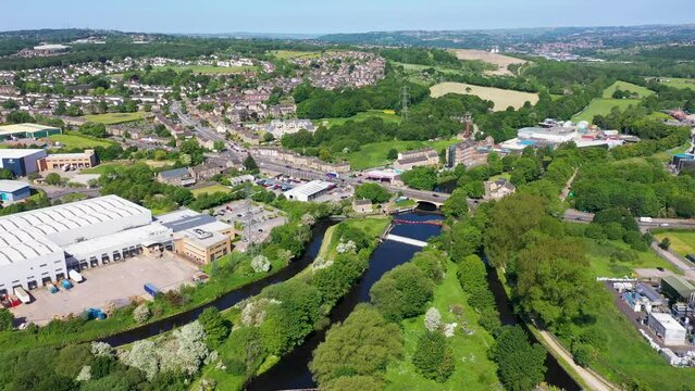 Aerial footage of the village of Kirkheaton, Huddersfield in the Kirklees district in the county of West Yorkshire England showing the village and River Calder from above in the summer time.