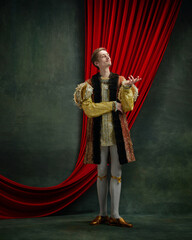 Portrait of young man, royal person, prince in retro clothes standing with noble, thoughtful look...