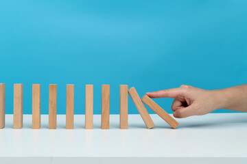 People hand pushing domino pieces