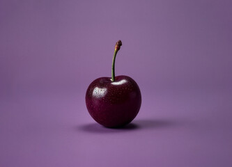 close up cherry on a violet background