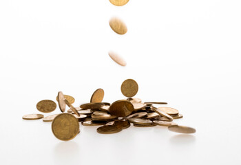 Golden coins falling on white background