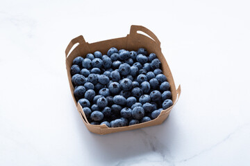 paper box with fresh blueberry food summer concept