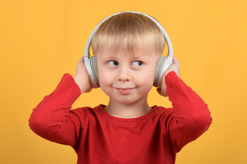 boy child enjoys music in headphones