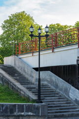 Fototapeta na wymiar lantern near stair steps in the city park in spring. travel background