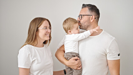 Fototapeta premium Family of mother, father and baby smiling together over isolated white background