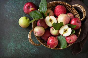Fruit background, organic fruits. Still life food. Basket of ripe apples on a stone table. View from above. Copy space.
