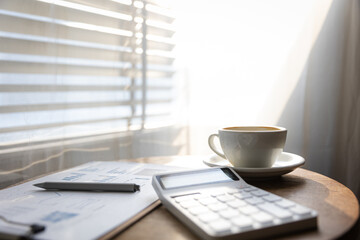Start your working day with hot latte coffee cup background, laptop and mobile phone at work.