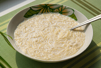 Milk vermicelli soup, children's and diet food, healthy breakfast close-up