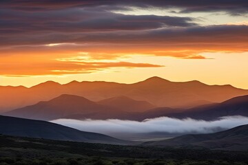 sunset over scenic mountain range, with clouds and mist in the air, created with generative ai
