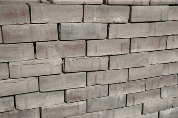 Old square paving slabs laid out in vertical rows. Processing of materials, recycling and storage of bricks.