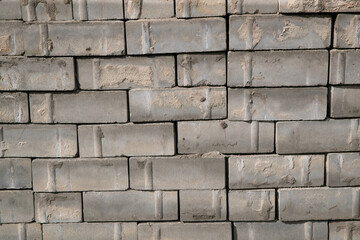 Old square paving slabs laid out in vertical rows. Processing of materials, recycling and storage of bricks.