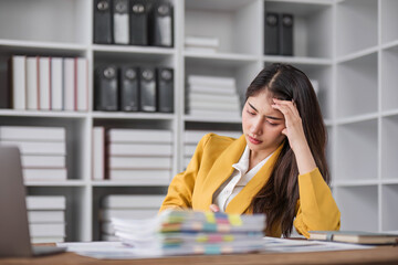 asian business woman thinking solving problem at work, worried serious young asian woman concerned make difficult decision lost in thought reflecting sit with laptop.