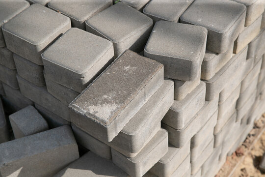 Old square paving slabs laid out in vertical rows. Processing of materials, recycling and storage of bricks. © Дмитри Лобакин