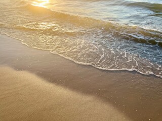 Sunshine reflection on the sandy sea coastline, golden hour, wat sea sand, evening sunlight on the sea shore 