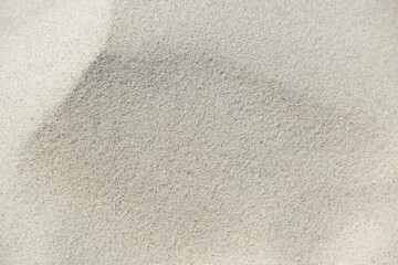 Fototapeta na wymiar White sand texture. Sand on the North sea beach as background. Natural pattern, sand surface, abstract background