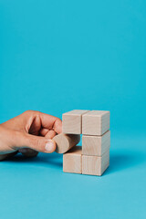 man plays with toy blocks