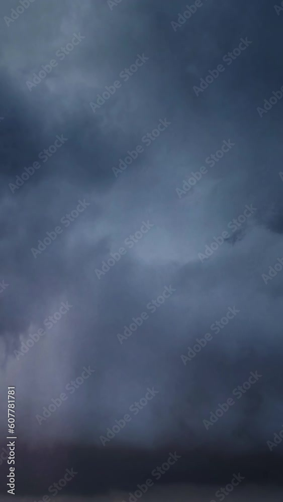 Wall mural lot of lightning during a thunderstorm. storm clouds are moving fast on the viewer, timelapse. verti