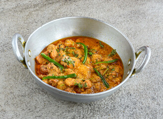 chicken boneless handi korma served in karahi isolated on grey background top view of pakistani and indian spices food