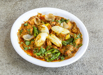 chicken jalfrezi served in plate isolated on grey background top view of pakistani and indian spices food