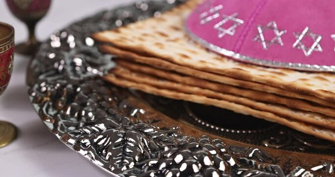 Jewish holiday Passover is kosher unleavened matzah bread and cup of kosher kiddush wine for Pesach