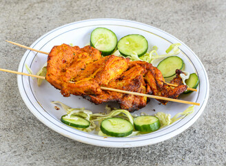 chicken tikka breast piece served in plate isolated on grey background top view of pakistani and indian spices food