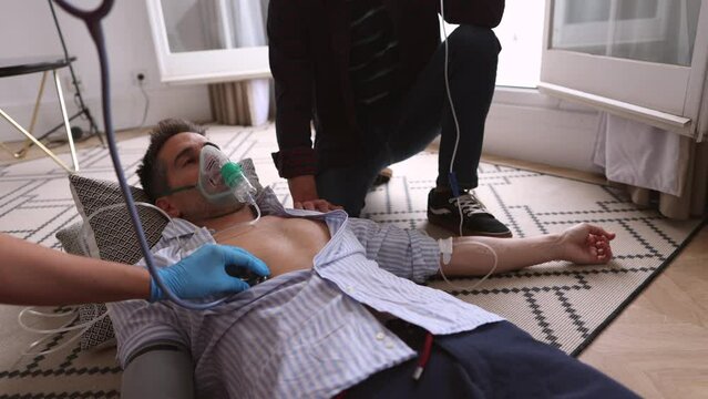 Emergency help for unconscious man, First aid preparation Emergency CPR for female doctor taking care of man with heart attack at home, A part of resuscitation process: healthcare and insurance concep