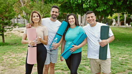 Group of people smiling confident holding yoga mat at park