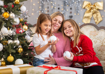 Mom with daughters celebrating new year at home