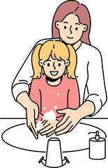 Happy mother and daughter washing hands