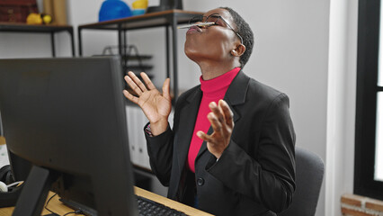 African american woman business worker playing with pen on mouth at office