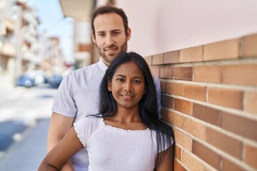 Man and woman interracial couple standing together at street