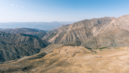 Fototapeta na wymiar Highlands of Iran in the mid day sun, peaks, no vegetation, mountain chain, Alborz mountain range 