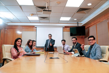 Indian business people showing thumps up at office