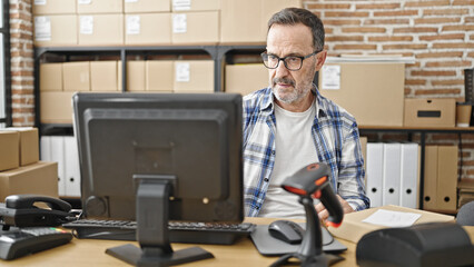 Middle age man ecommerce business worker using computer at office