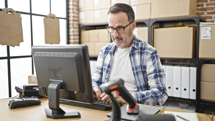 Middle age man ecommerce business worker using computer at office