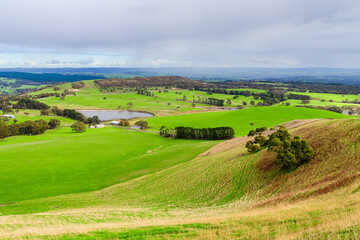 Fototapeta premium Adelaide Hills green farmlands during winter season from above, South Australia